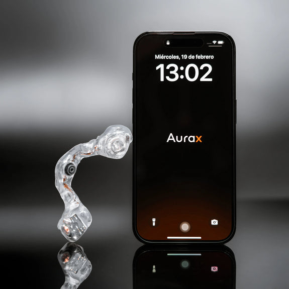 MouthX hands-free controller next to a smartphone displaying the Aurax logo, used as cover image for Telecinco press release.